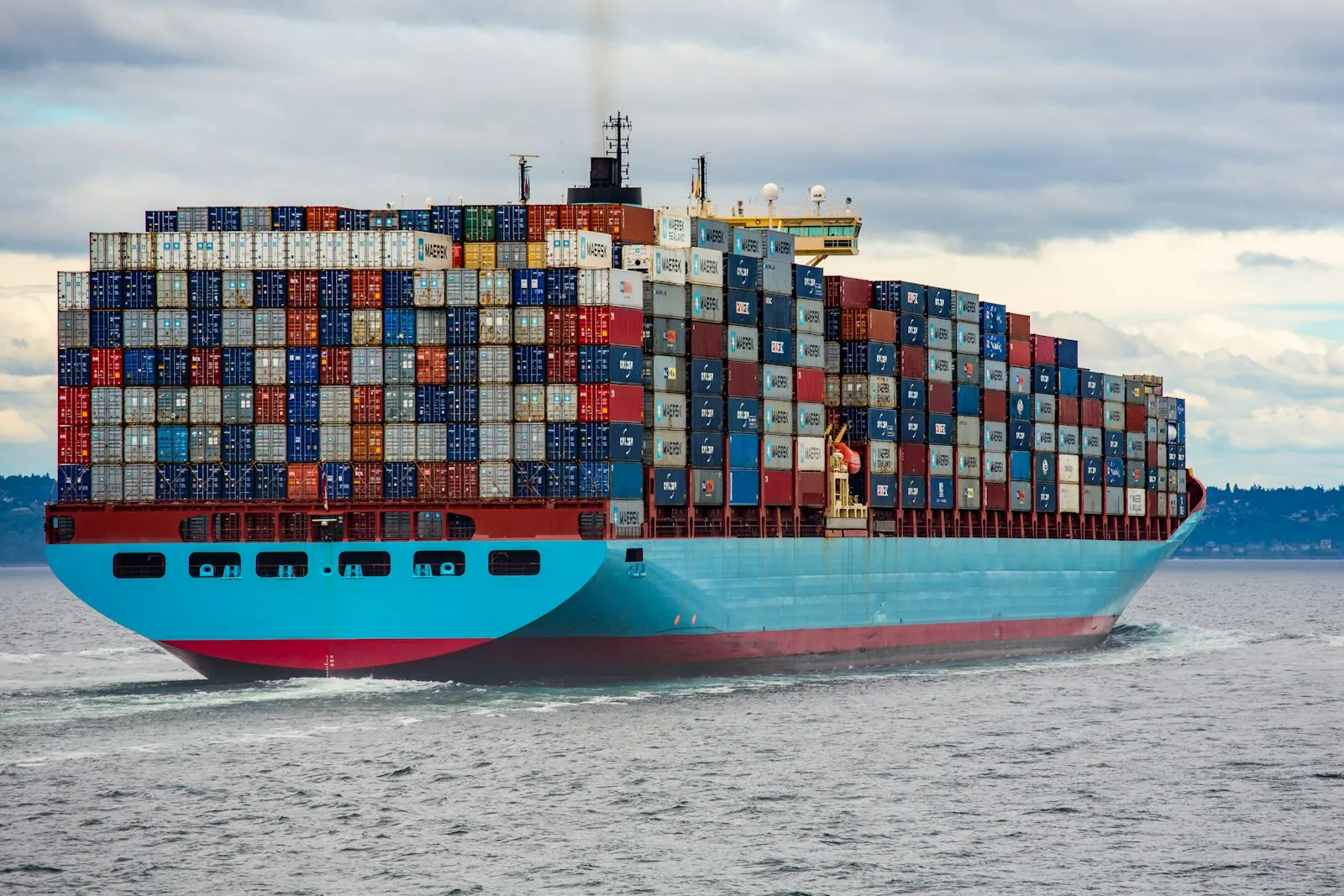 Container ship loaded with colorful cargo at sea