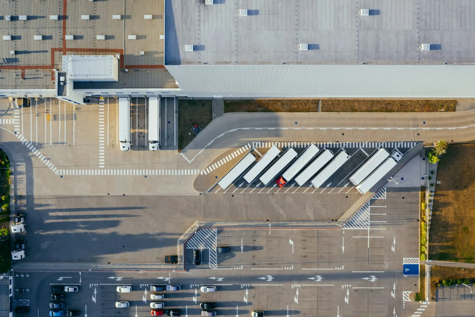 Aerial view of a distribution warehouse with trucks at the loading docks