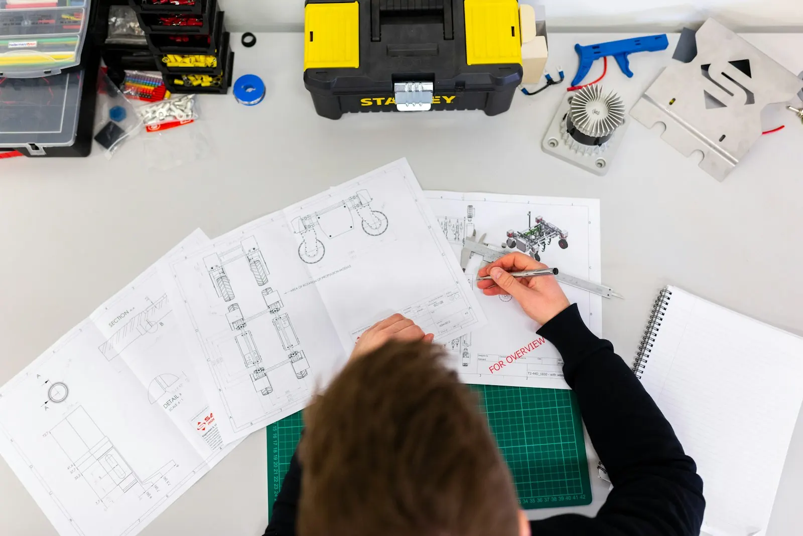 Engineer sketching process diagrams on paper